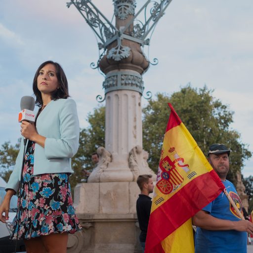 Nolan Ryan Trowe, VII Mentor Program, August 29, 2018; Barcelona, Spain: A news anchor and a protester stand near the Passeig de Pujadesa during a Catalonian protest.