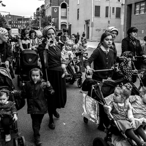 Nolan Ryan Trowe, VII Mentor Program, June 10, 2018; Williamsburg, Brooklyn; Jewish mothers and children follow behind a group of Jewish men who are celebrating the gift of a new Torah to a local synagogue.