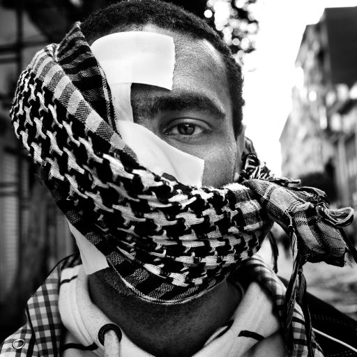 Portrait of a protester in Tahrir Square, Cairo, Egypt, Feb. 4, 2011. Hundreds of thousands of Egyptians gathered in Tahrir Square today, which marks the 11th day of the uprising, praying, chanting slogans, and waving flags in a chiefly peaceful demonstration for the expulsion of President Hosni Mubarak. In contrast to the last two days, there were few signs of the violent government supporters who anti-Mubarak protesters said were assembled by the Mubarak government.
