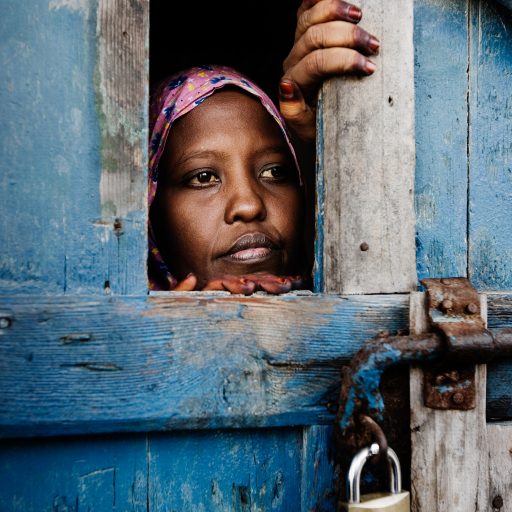 Samira Abdirahman, 30, peers through a prison cell door at the Galshire prison, formerly an Italian fort, in Mogadishu, Benadir region, Somalia on Nov. 13, 2008. Abdirahman received a six month jail sentence for selling drugs. Nearly two years after Ethiopian forces led an armed intervention to oust Somalia's Islamic Courts Union from power, the impoverished country has seen some of the deadliest violence in its history. A staggering 600,000 Somalis have fled the capital city from February to November of 2007 alone. Nearly half of the city is deserted with over one million internally displaced persons, IDPs, taking refuge in one of the hundreds of over crowded camps in and around the city.