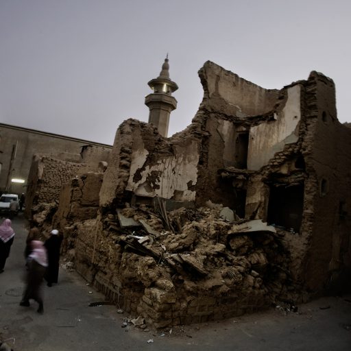 Saudis walk past a destroyed building in Riyadh, Saudi Arabia on Jan. 9, 2008. Mosques and poor areas of the city are where al Qaeda and other insurgent groups try to recruit members.