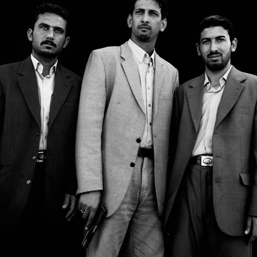 Ali Abdul Hussein, left, Mohammed Abdul Redha, center, and Ahmed Khalaf, right, Shiites loyal to Muqtada al Sadr, stand for a portrait in Baghdad, Iraq on March 2, 2006.  They work in the local office of Muqtada Al Sadr who, after a Sunni mosque was attacked, helped to secure it. These individual portraits show the faces of those trapped in the middle of the civil war.