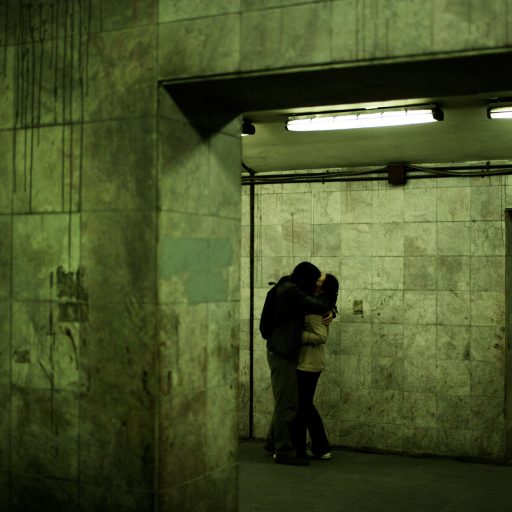 A couple kisses in a pedestrian tunnel under the city in Shanghai, China, Dec. 8, 2004. Shanghai is a frontier city that separates one world from another, where the centuries-old traditions of the east are bathed in the neon glow of the west.