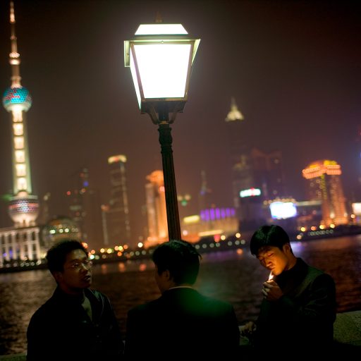 Young people gather at the famous Bund waterfront boardwalk in Shanghai, China, Dec. 8, 2004. In Shanghai the centuries-old traditions of the east are bathed in the neon glow of the west.