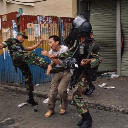 A military commander kicks a looter who was stealing a music cassette in Jakarta, Indonesia. As madness descended onto Indonesia, tens of thousands took to the streets of the nation's capital rioting and burning the city calling for then President Suharto to resign. A few days later he left the presidency under pressure of the people. Over 500 people died during the three-day rampage.May 1, 1998Photo by: John Stanmeyer / VII