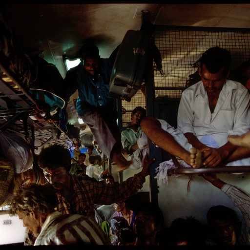 Daily life inside the packed 3rd class car on the Amritsar to Kadihar Express, about 2 1/2 hours outside of Delhi heading towards Kadihar. Over 200 people manage to cope even in such over filled railway cars.