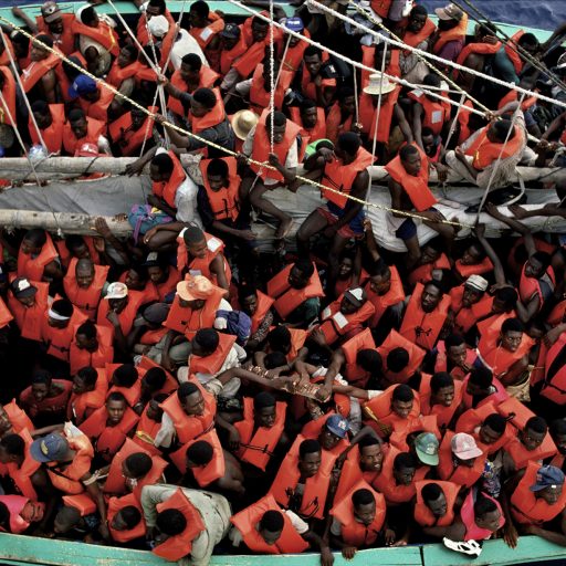 Donning lifejackets thrown to them by the U.S. Coast Guard, 468 Haitians are crammed in the 55-foot Merci Jesus, desperately trying to flee their home. They were intercepted off Haiti’s coast in the Gul of Mexico.