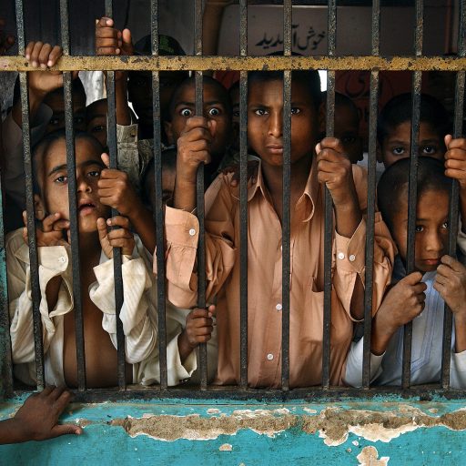 Locked behind bars, children as young as seven, languish at the Edhi Village for the mentally ill located outside Karachi, Pakistan. In Pakistan, the government has all but given up on caring for the mentally ill, having to ask private donors to handle the care. More than 1,000 mentally ill patients live jammed together in the privately funded Karachi commune called Edhi Village, run by the prominent social worker Abdus Sattar Edhi. Iron gates lock the inmates in, some of whom, stark naked, slam their heads against the walls of their dark cells. "Our center is becoming a dumping ground for people who consider mentally ill people as the dirt of society," says Ghazanfar Karim, the complex's overburdened supervisor.