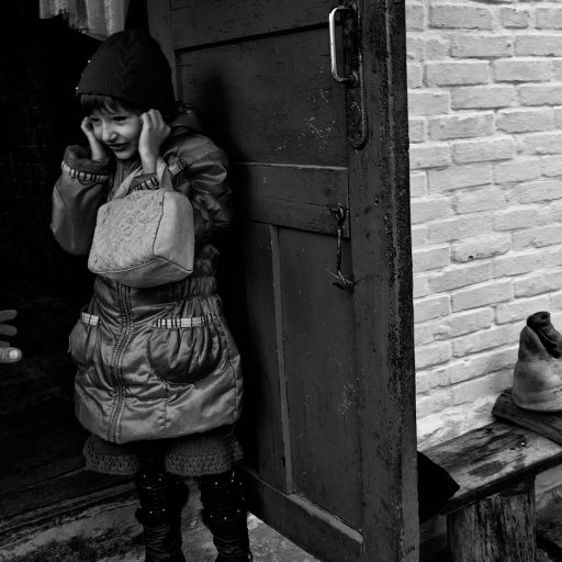 Masha, 5 year old girl is watching her grand father while he is killing a pig in Termahivka