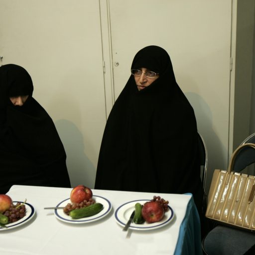 At one of Tehran government's women well being center, a refuge for single women or women who has social problems. Mrs Eftekhari, deputy at the Iranian Parliement wearing the Islamic Chador, is visiting the refuge, invited there for an Iftar party, during the holy month of Ramadan. October 2004, Tehran, Iran