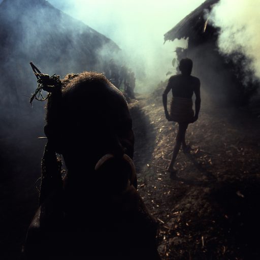 Smoke from roasting pigs and sweet potatoes fills the air as the Yali people of highland Irian Jaya prepare a feast in the late morning light, in Indonesia.Photo by: Alexandra Boulat / VII