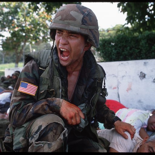American soldier with wounded civilians.