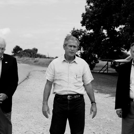 Flanked by U.S. Vice President Dick Cheney and Secretary of Defense Donald Rumsfeld, U.S. President George W. Bush addresses reporters on a road outside his ranch in Crawford, Texas, August 23, 2004.

Photo By: Christopher Morris / VII