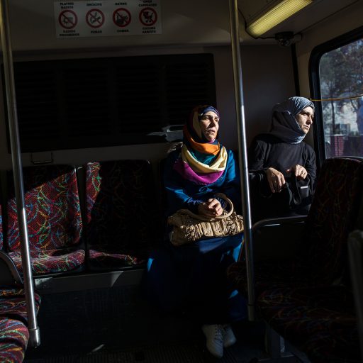 Ghazwa Aljabooli and her friend, Mumena El Ali, ride the bus while on their way to their Des Moines Area Community College (DMACC) ESL class.

Ghazwa Aljabooli and her husband, Abdul Fattah Tameem, are refugees from Syria who were placed in Des Moines, Iowa with their five children.  The family's hometown of Homs has seen some of the most fierce fighting and destruction of the civil war in Syria.  For two years the family fled fighting within Syria before making it to Jordan, where they began the long process of of getting refugee status in the United States.  From Jordan, Aljabooli and Tameem and their children were flown to Iowa to start a new life in middle America.  While the transition has not been easy Tameem says, "the only positive thing is my kids are safe, this is essential."

Iowa's Republican Governor, Terry Branstad, has apposed Syrian refugees being placed in his state.  The federal government is in charge of refugee settlement though, and the U.S. Committee for Refugees and Immigrants, a nonprofit that contracts with the U.S. Department of State, settled the Tameem family in Des Moines.