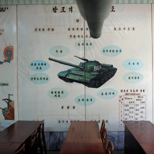 Behind the Curtains series — The barrel of a tank and various diagrams of tank systems decorate a classroom in Pyongyang, North Korea.