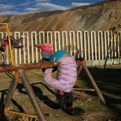 Children play in a playground bordering contaminated mine tailings in the Paragsha neighborhood of Cerro de Pasco, Peru.