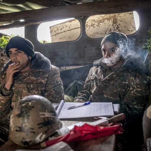 Lieutenant Vahe Avanesyan, 27, and soldier Harut Gasparyan,19, wait in a trench at a frontline post after an order to hide, during the Nagorno Karabakh Four-Day war in Martakert on April 4, 2016.