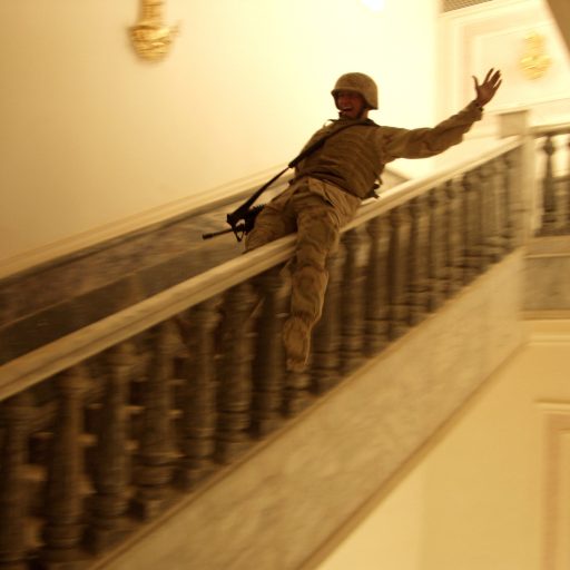 A US Marine slides down the marble handrail in Saddam's extravagant palace built in his home town of Tikrit, Iraq on April 14, 2003. 

The Palace is not only enormous, but contains rugs worth hundreds of thousands of dollars, and a river was re-routed to pass the palace as a show of the Hussein families wealth. 

Tikrit was the last major city in Iraq to fall, and many people felt it symbolized the end of the fighting in Iraq. (Photo by Ashley Gilbertson / VII Network)
