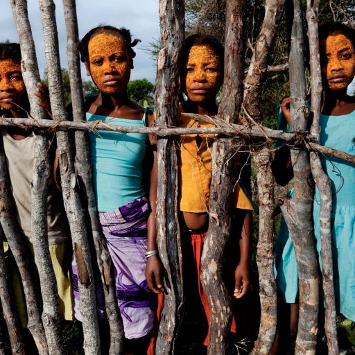 These young girls, ages 11-13, use a paste made from the tsiambara plant's roots to beautify their skin. The meaning of this process is called "I don't want to show you". Madagascar 2010
