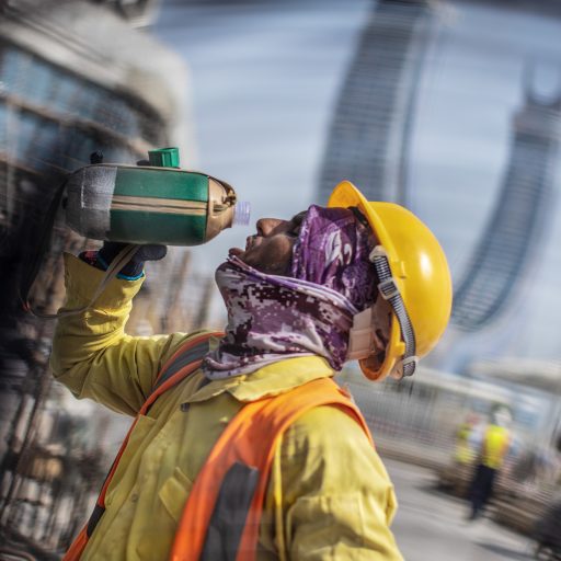 Migrant workers toil in intense heat and humidity at a construction site in Lusail City, Qatar on August 18, 2022.