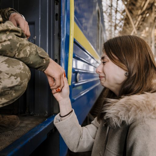 LVIV, UKRAINE - 15TH OF MARCH, 2022:  
Soldier Volodimir (20, l) and his girlfriend Tanya (21) while saying goodbye at the trainstation in Lviv, Ukraine on March 15th 2022. He departs to Kramatorsk, to fight in the war that started after Russia invading Ukraine on the 24th of February 2022. CREDIT: Ilvy Njiokiktjien