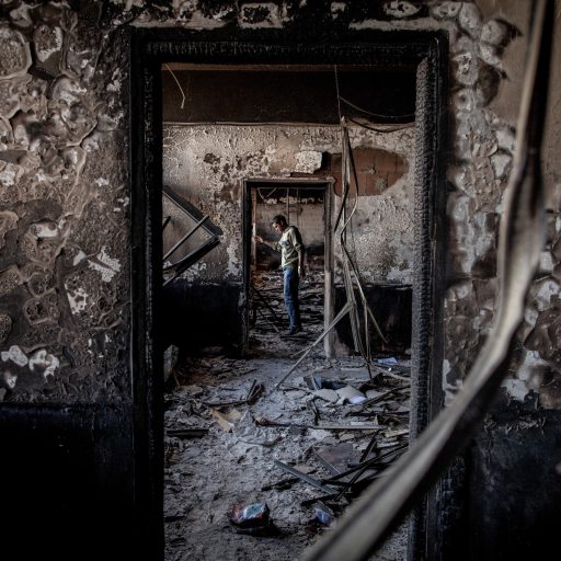 A man in a government building on the outskirts of Benghazi that had been burned by the opposition.