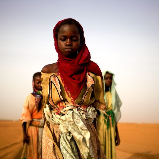 Young Darfur girls leave a camp to gather firewood. Girls as young as eight have been raped, attacked, and killed trying to get wood during the genocide in Sudan.