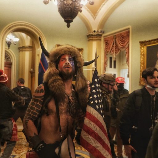 Trump supporters, including Jake Angeli, the "QAnon shaman," break into the Capitol on January 6, 2021, in protest of the certification of Joe Biden as the next United States President.