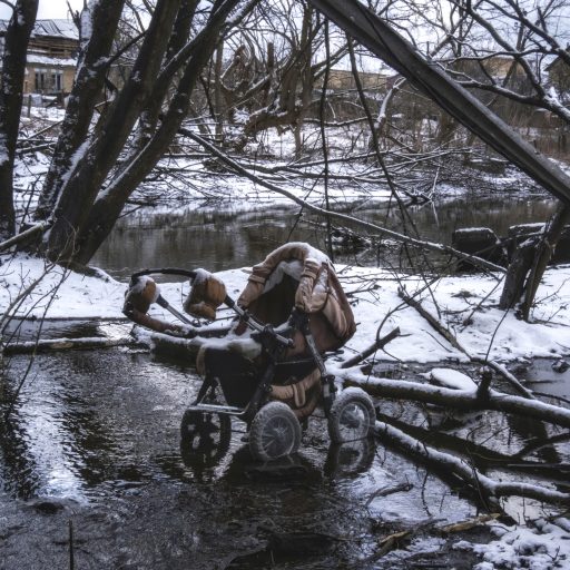A stroller lies abandoned at a crossing to safety where Ukrainians fled Russian forces who were advancing in the town of Irpin during the Russia/Ukraine war.