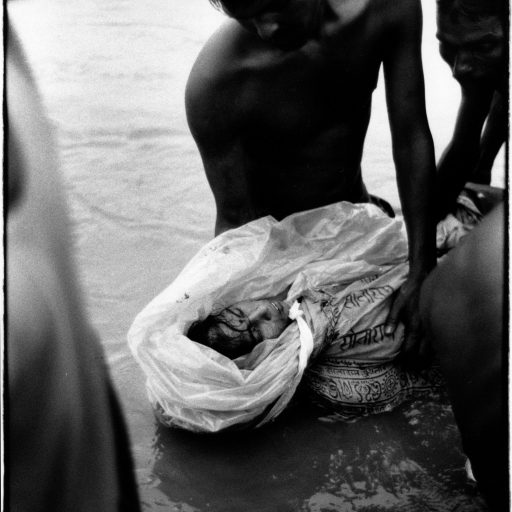 A victim of a Maoist bomb blast, Sunita is bid farewell by her husband, Vijaya and her brother. Being from a poor family, her male relatives buried her in a river, an hour's ride by horse and cart from Nepalganj. Nepal 2004