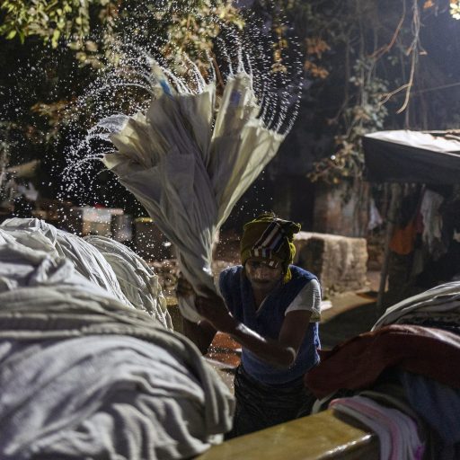 Dhobi Khana. Kolkata. India. February 6, 2023. 
Laundry being beaten and wrung. Established in 1902, the dhobi ghat has acted as the primary laundry service for hospitals, restaurants, hotels and salons in Kolkata.