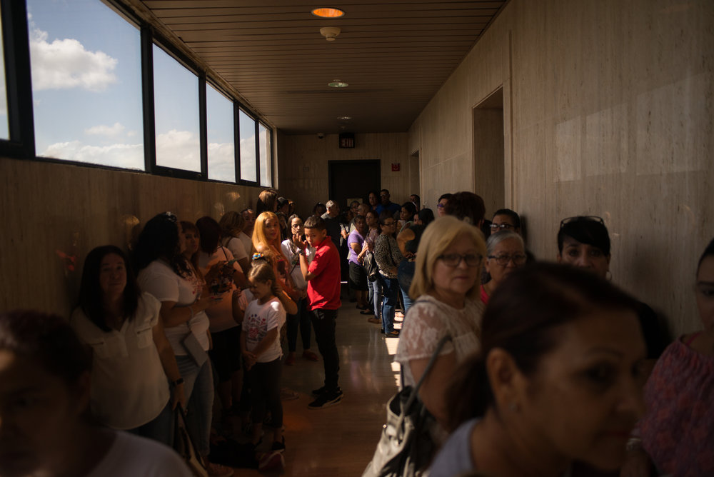  6/11/18 – Arecibo, Puerto Rico – Families and teachers of schools that are to be closed before the Fall 2018 academic year wait in the Judicial Center of Arecibo for the public hearing from the Department of Education about their reasonings for closing schools. The Puerto Rican Department of Education is closing 283 schools, and moving multiple schools into the same building, citing the past year’s drastic drop in enrollment as one of the primary reasons to lower the amount of schools, and instead increase the amount of students in each school. Students of special education schools are one of the groups to be most negatively affected by these closings, as the new schools may not offer the resources the students need and have access to at their current schools. (Sofie Hecht Photography) 