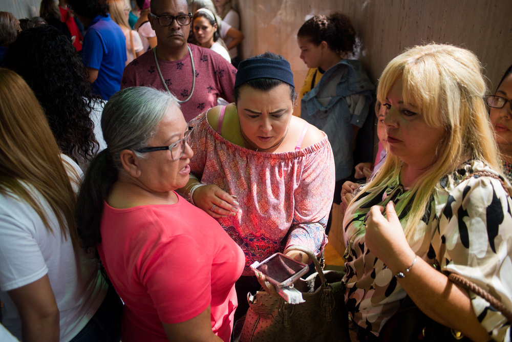  6/11/18 – Arecibo, Puerto Rico – Families and teachers of schools that are to be closed before the Fall 2018 academic year wait in the Judicial Center of Arecibo for the public hearing from the Department of Education about their reasonings for closing schools. The Puerto Rican Department of Education is closing 283 schools, and moving multiple schools into the same building, citing the past year’s drastic drop in enrollment as one of the primary reasons to lower the amount of schools, and instead increase the amount of students in each school. Students of special education schools are one of the groups to be most negatively affected by these closings, as the new schools may not offer the resources the students need and have access to at their current schools. (Sofie Hecht Photography) 