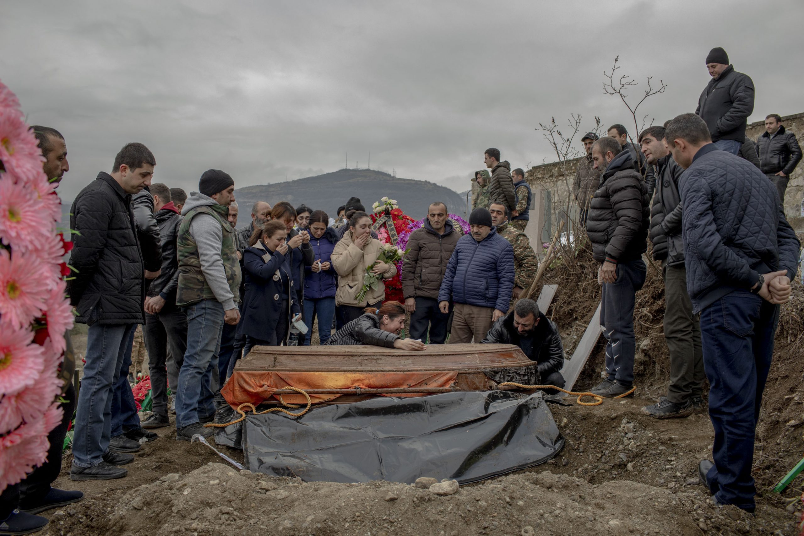 Anush Aleksanyan cries over the coffin that carries her son Erik Hovsepyan, 18, in Stepanakert, Nagorno-Karabakh on December 19, 2020. Erik is buried for the second time, his coffin was transferred from Nagorno-Karabakh's Taghavard village to Stepanakert, as Taghavard came under Azerbaijan's control.