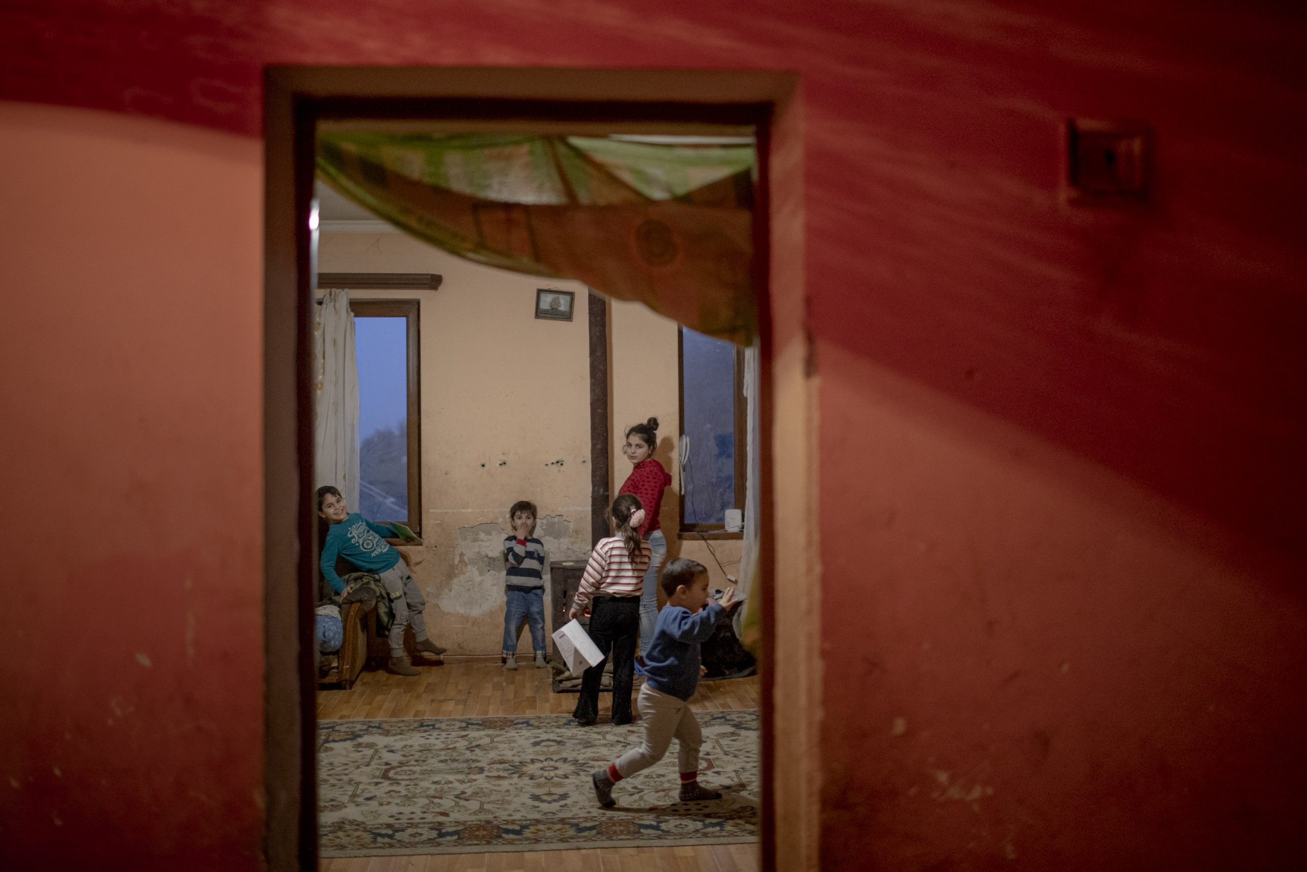 Five of the ten Babayan children in the living room of their home in Stepanakert, Nagorno-Karabakh, on December 19, 2020. The Babayan family returned to their home in Stepanakert a few days after the war ended.