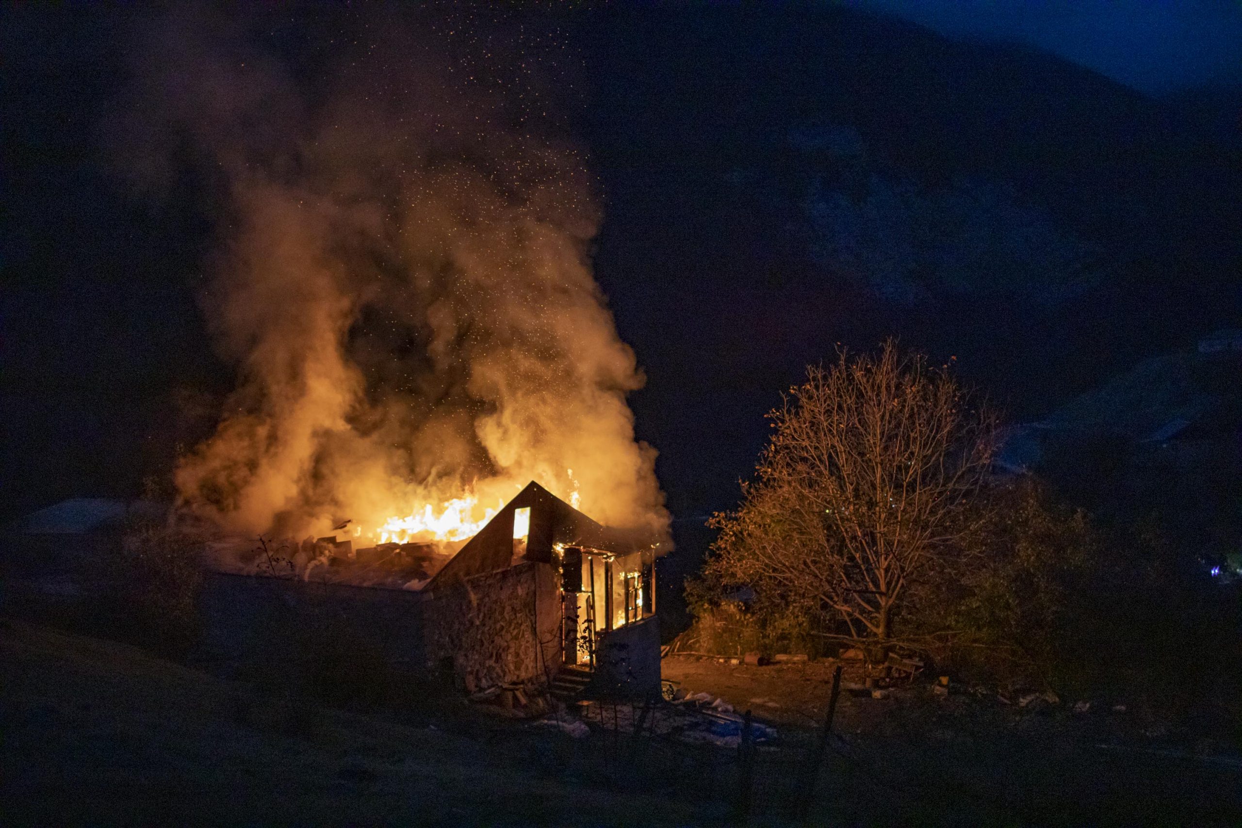 House set on fire by its owners, close to Dadivank Monastery in Kalbajar region, seen on November 14, 2020. Kalbajar is one of the regions surrounding Nagorno-Karabakh, turned over to Azerbaijan as the Nagorno-Karabakh war ended. In numerous cases Armenians burned their houses in this region, in order for them not to be inhabited by people moving here from Azerbaijan.