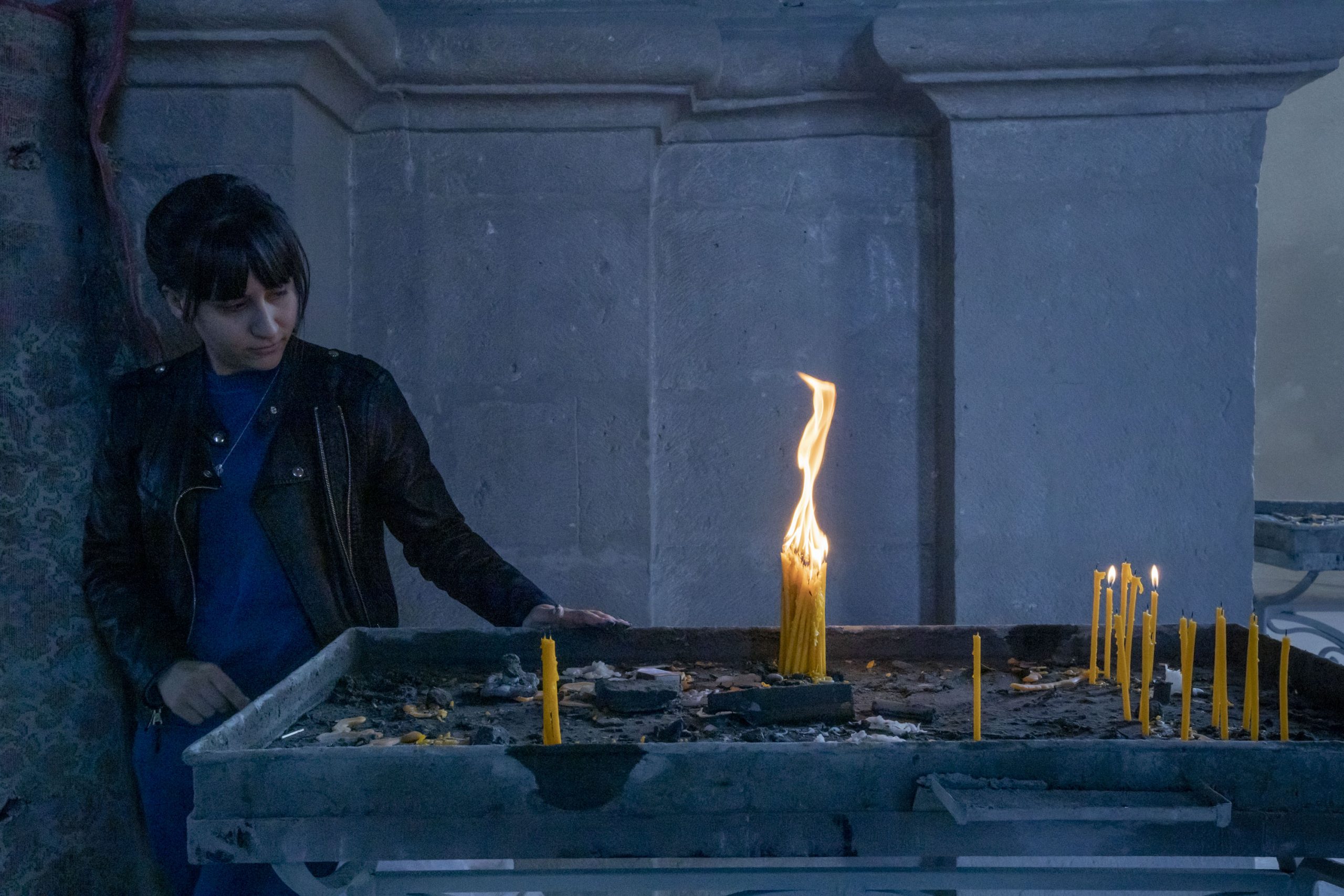 A woman looks at 31 candles she has lit for a missing soldier in Ghazanchetsots Cathedral in Shushi, Nagorno-Karabakh, on October 16, 2020. She notes that she lit as many candles as is his age. The cathedral was shelled twice on October 8, 2020. The town, which Armenians call Shushi and Azerbaijanis call Shusha, came under Azerbaijan's control by the end of the Nagorno-Karabakh war.