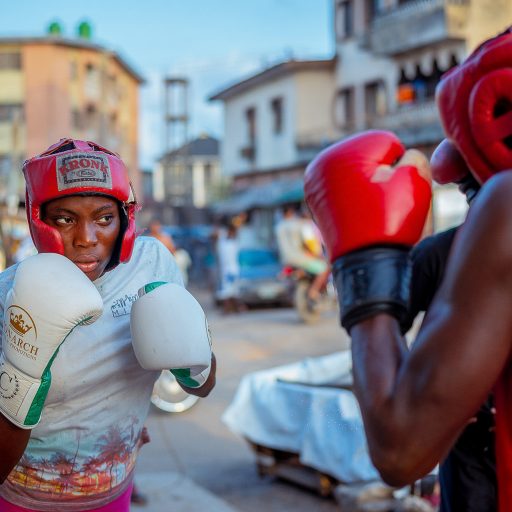 A girl boxing on the street in Lagos.