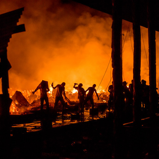 The settlers of Agats in Yos Sudarso Street market area try to extinguish the fire in Agats central market, 25 May 2015. The fire consumes over 60 standing-on-stilts structures (kiosks, houses, and warehouses combined) belonging to mostly traders in Agats.