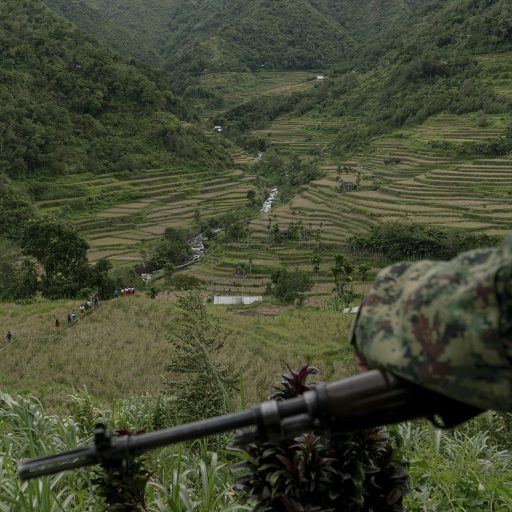 A cop watches over Hapao Rice Terraces where the Igorot of Hungduan descend their way to Punnuk, a tugging ritual to celebrate harvest in Hapao, Ifugao in the Philippines on Saturday, August 10, 2019. The ritual is an age-old tradition in Hapao that died down and was only revived 20 years ago in an effort to pass down cultural practices to younger members of the tribe.
