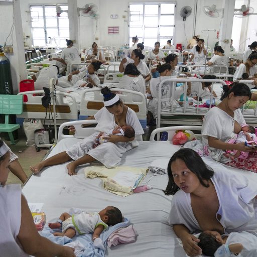 Newly given birth patients share a bed in Fabella Hospital in Manila on October 21, 2018. Dr. Jose Fabella Memorial Hospital is considered the busiest maternity hospital with an average of 60 births a day from the poorest patients in Manila and nearby provinces.