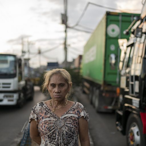 Anita Lerio stands in the middle of the road in Tondo, Manila on January 11, 2020. Lerio lost her son in 2017, and her husband in 2019. She has taken over her husband’s job of watching over a tiny parking spot in front of Parola, a slum in Manila, earning $3 a day. “It hurts because we celebrated Christmas and New Year without them. During special occasions, it’s my husband who’s pushing for us to celebrate. Last New Year, I forced myself to be happy and I danced outside alone, my neighbors were even looking.”