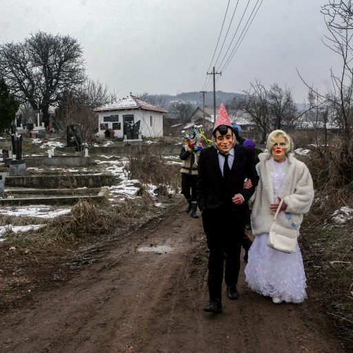 March 6, 2011 Glavica, Serbia.  A Newlyweds in masks from village Glavica go to church in nearby town Paracin, during a marriage parade, 200 km. southeast of Belgrade, Serbia, March 6, 2011. This is a part of Serbian traditional manifestation from the mid 19th century, which is named Komendija , meaning comedy in Serbian rustic language. Across Serbia, people gather in villages to celebrate the end of White Week, an old traditional festivity. Various magic acts, ways of dressing, songs and dances of the participants had purpose to drive away evil forces, ensure the fertility of both people and fields, and save people, livestock and land from the adverse impact of otherworldly and atmospheric elements.