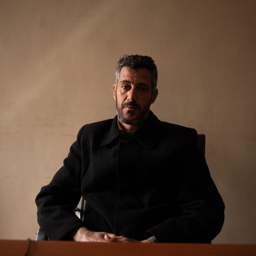 Mustafa Fraj Mohammed, whose brother is amongst the victims of Al-Kaneyat massacres, poses for a photo at the office of the ministry for the affairs of the families of the martyrs and missing persons at the municipal of Tarhuna on Feb 21, 2021 in Tarhuna, Libya. (Photo by Nada Harib/Getty Images)