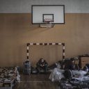 Photo by Espen Rasmussen / VII for VG. Ukrainian refugees seek shelter at a school gym in Przmysl, close to the Ukrainian border, on February 26, 2022. Many of the refugees have family and friends in Poland, while others are given shelter by Polish people.
