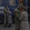 Photo by John Stanmeyer / VII. Alina and Victor (left), and Victoria and Yuri, give their partners a last goodbye on March 9, 2022, as they prepare to leave Lviv by train to fight against the Russians on the frontlines in Sumy.