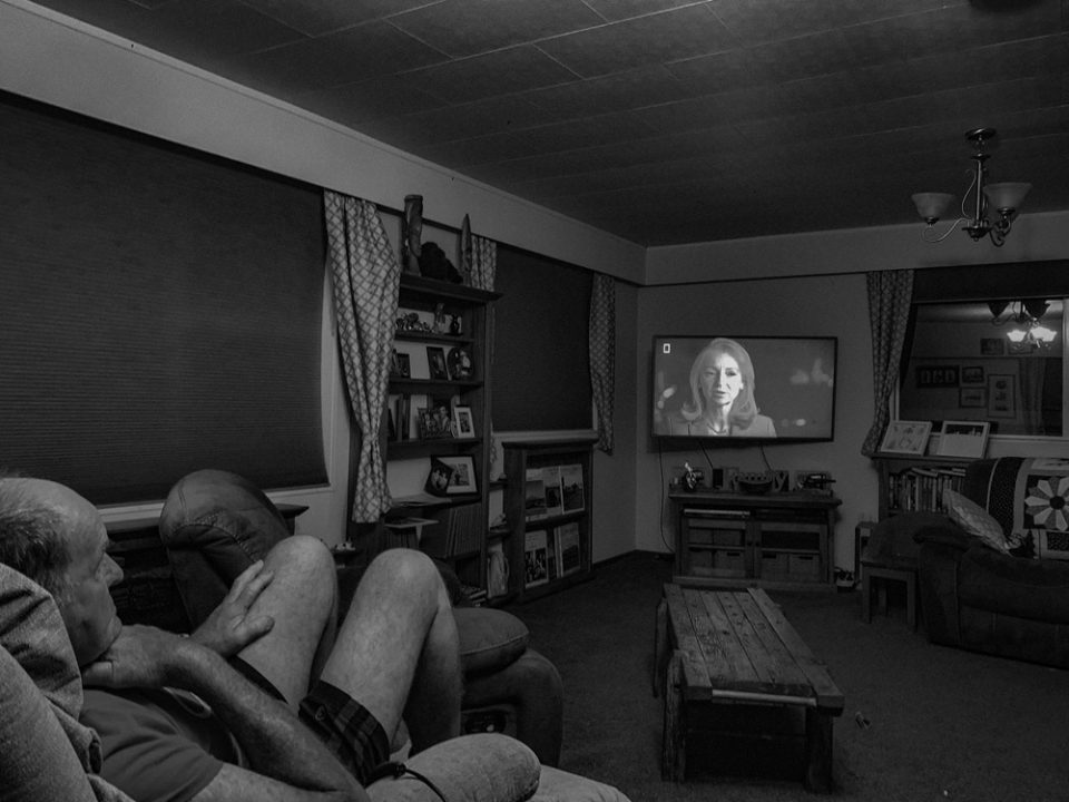Farmer watches nighttime television in his home. 4th February 2022, Auroa, Taranaki, Aotearoa, New Zealand