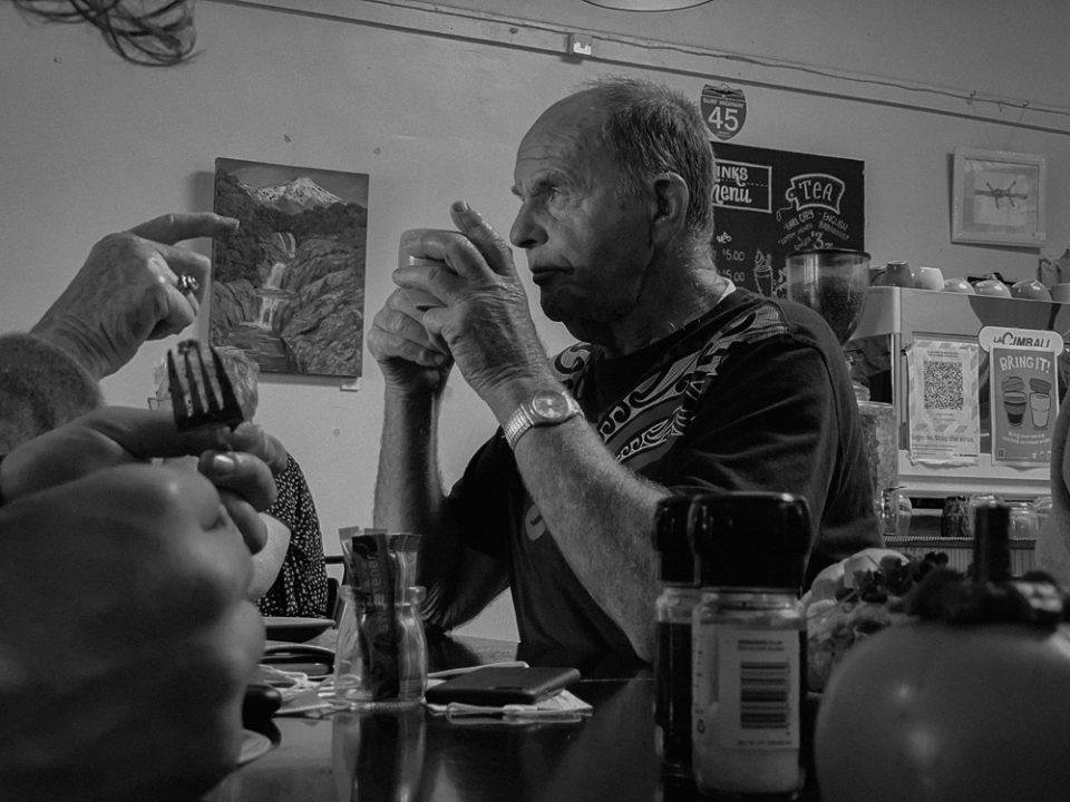 Retired farmer sits with a cup of coffee. 7th February 2022, Auroa, Taranaki, Aotearoa, Photo by Nick Netzler