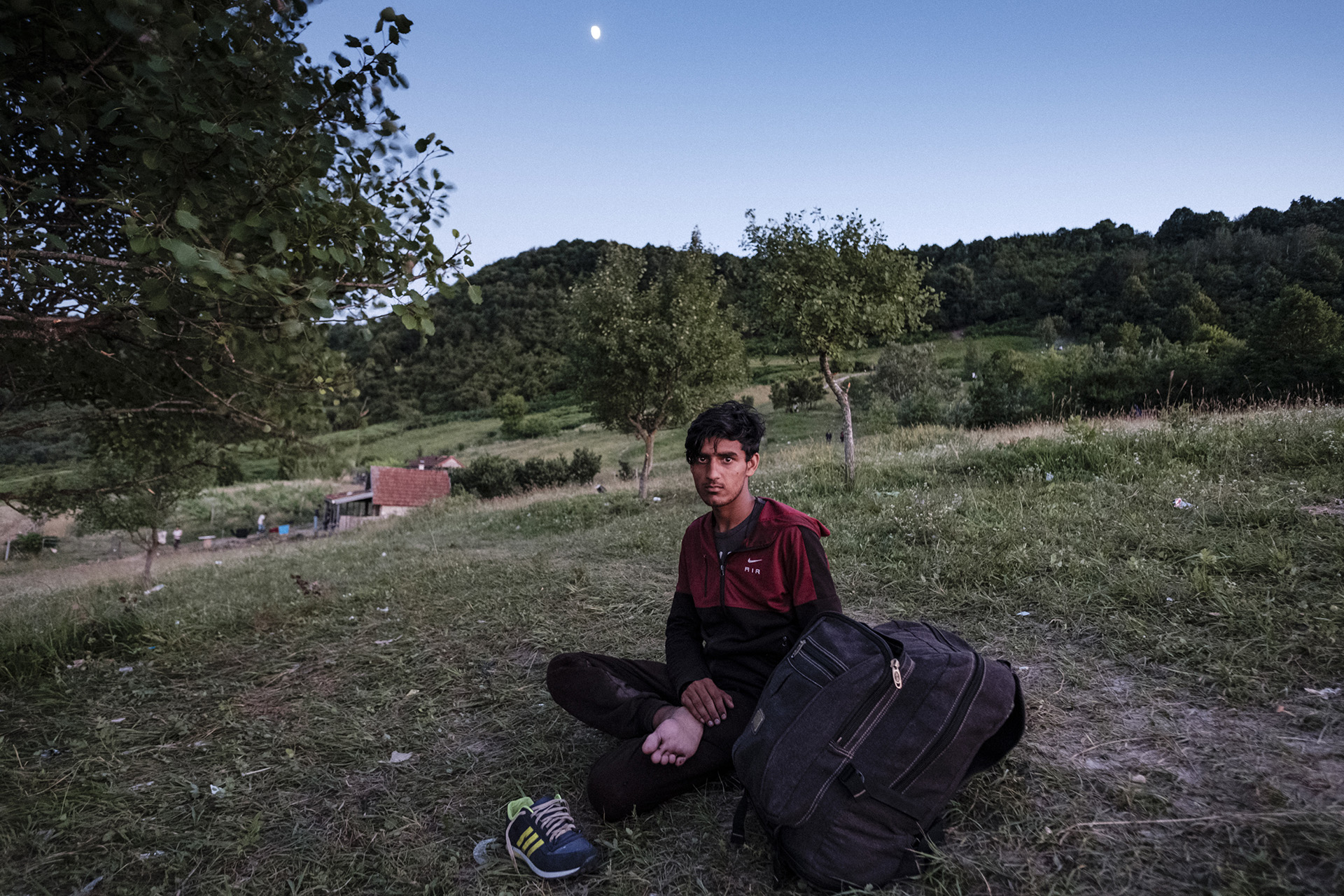 An Afghan refugee is seen resting near Bihać, northwestern Bosnia after being pushed back by Croatian police. ©Ziyah Gafic/VII
