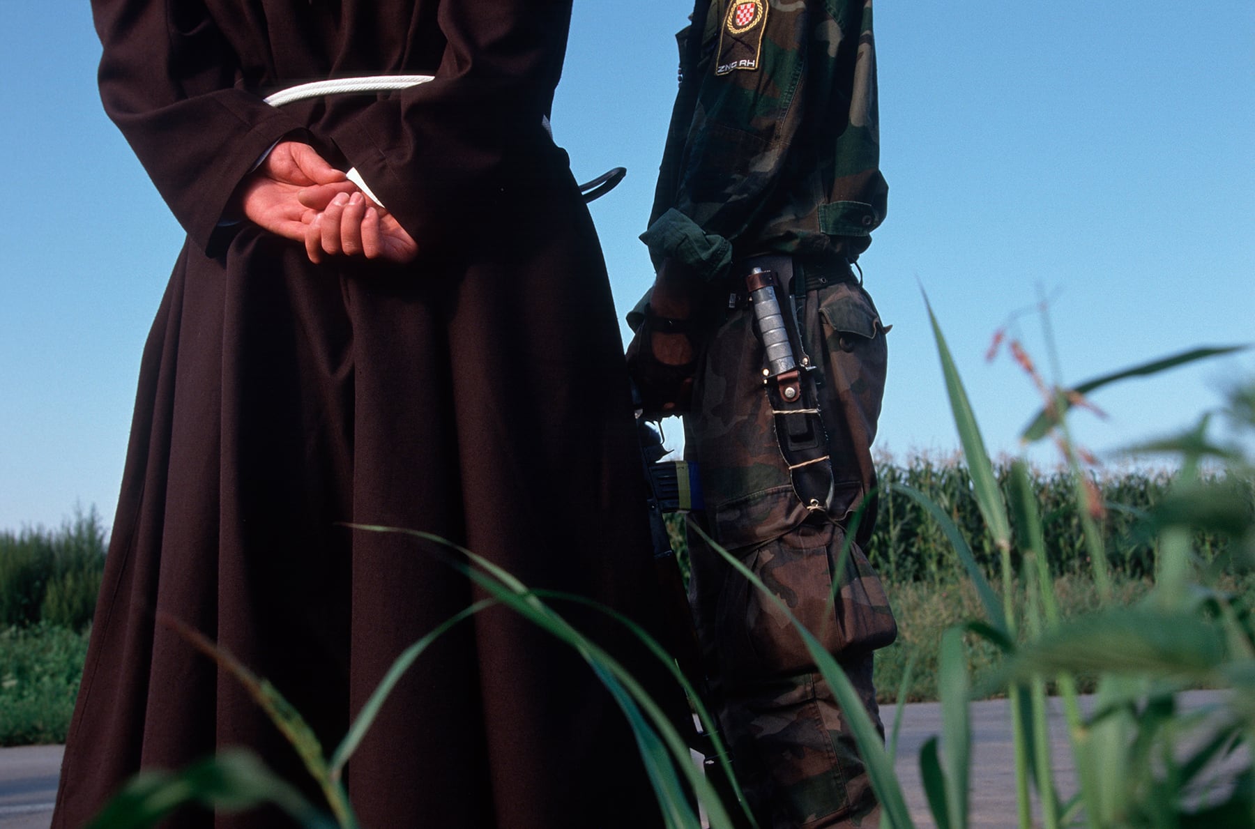 A Croatian soldier talks to a priest before leaving for battle, November, 1991. © Christopher Morris / VII Photo